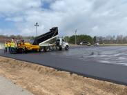 Anderson Brothers applying the bituminous wear course. Anderson Brothers applying the bituminous wear course.